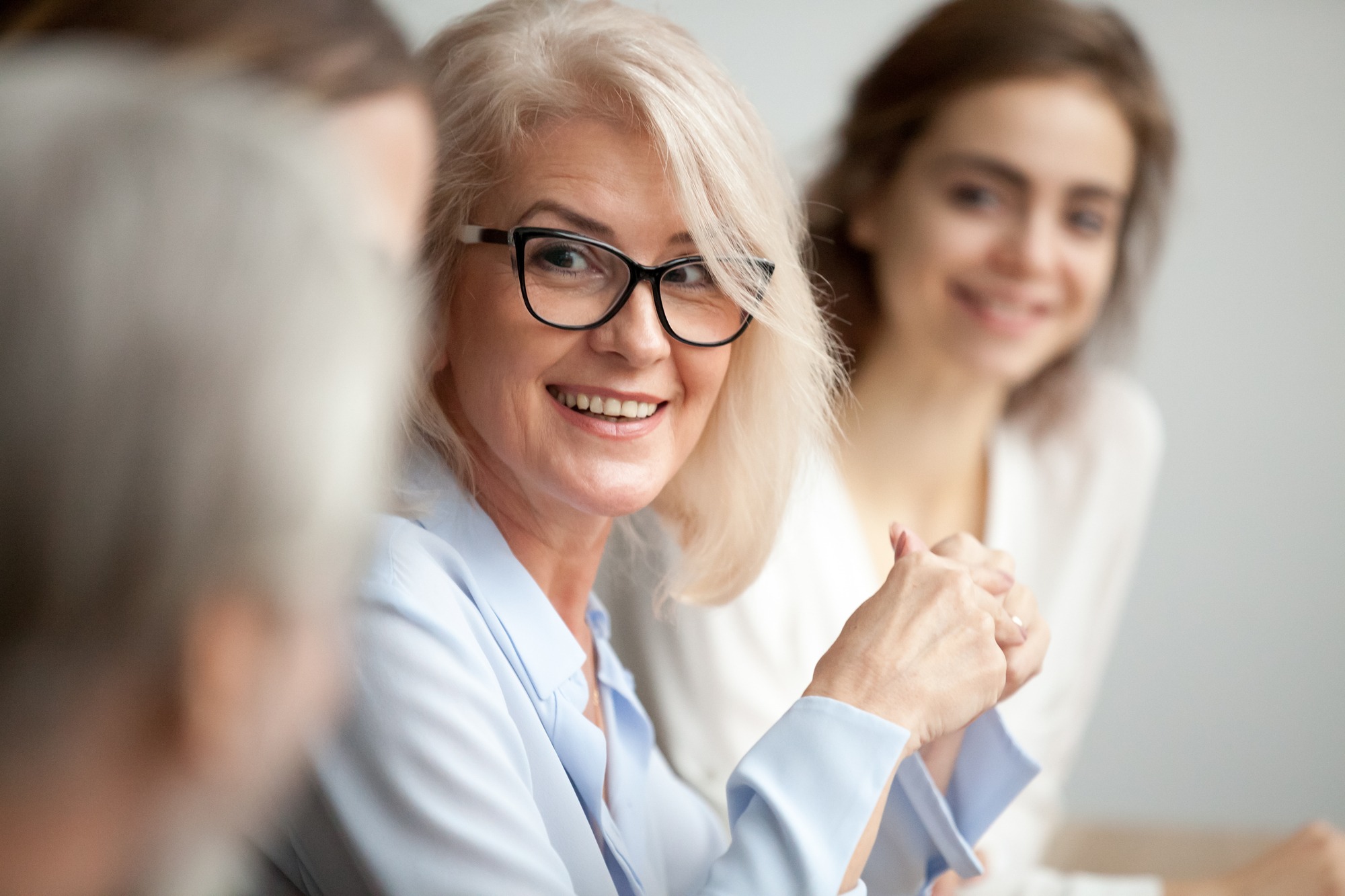 Smiling woman in a group panel