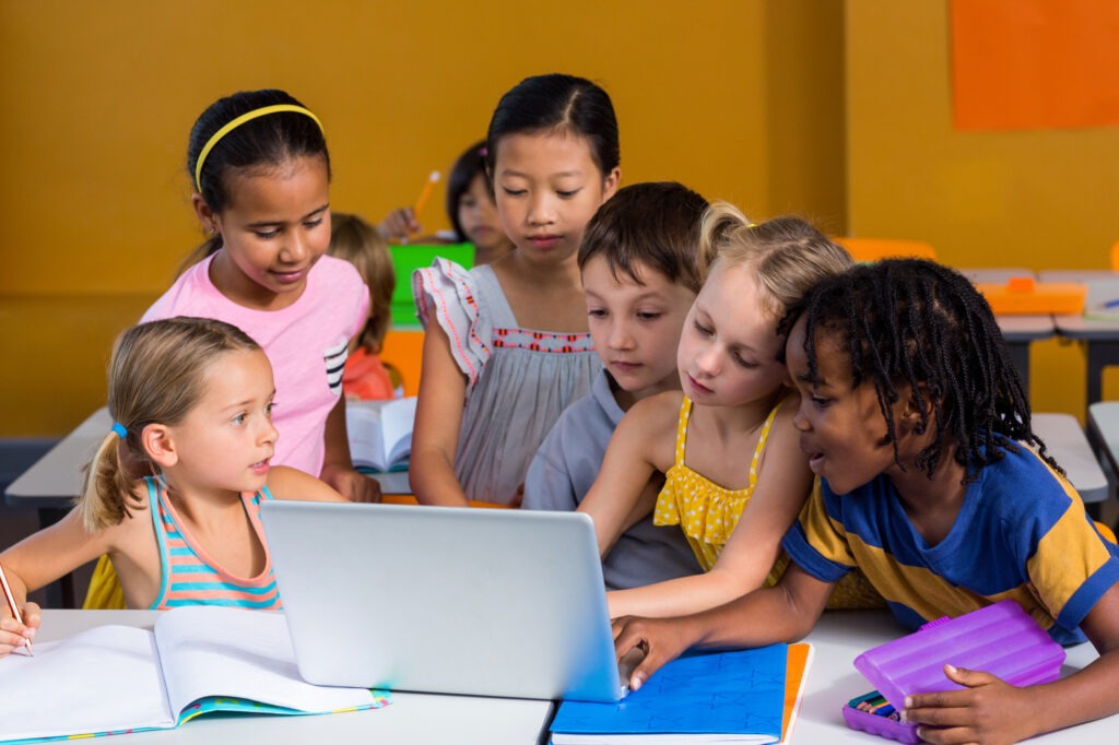 Cute children using laptop in clasroom